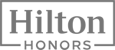 The image shows a logo with the words "Hilton Honors" in a bold font, surrounded by a rectangular border.