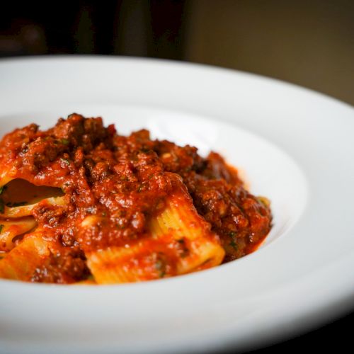 A plate of pasta with a rich, meaty tomato sauce.